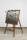 Photograph of a mirror with a gold frame on an easel. From the mirror spring stretched trophies